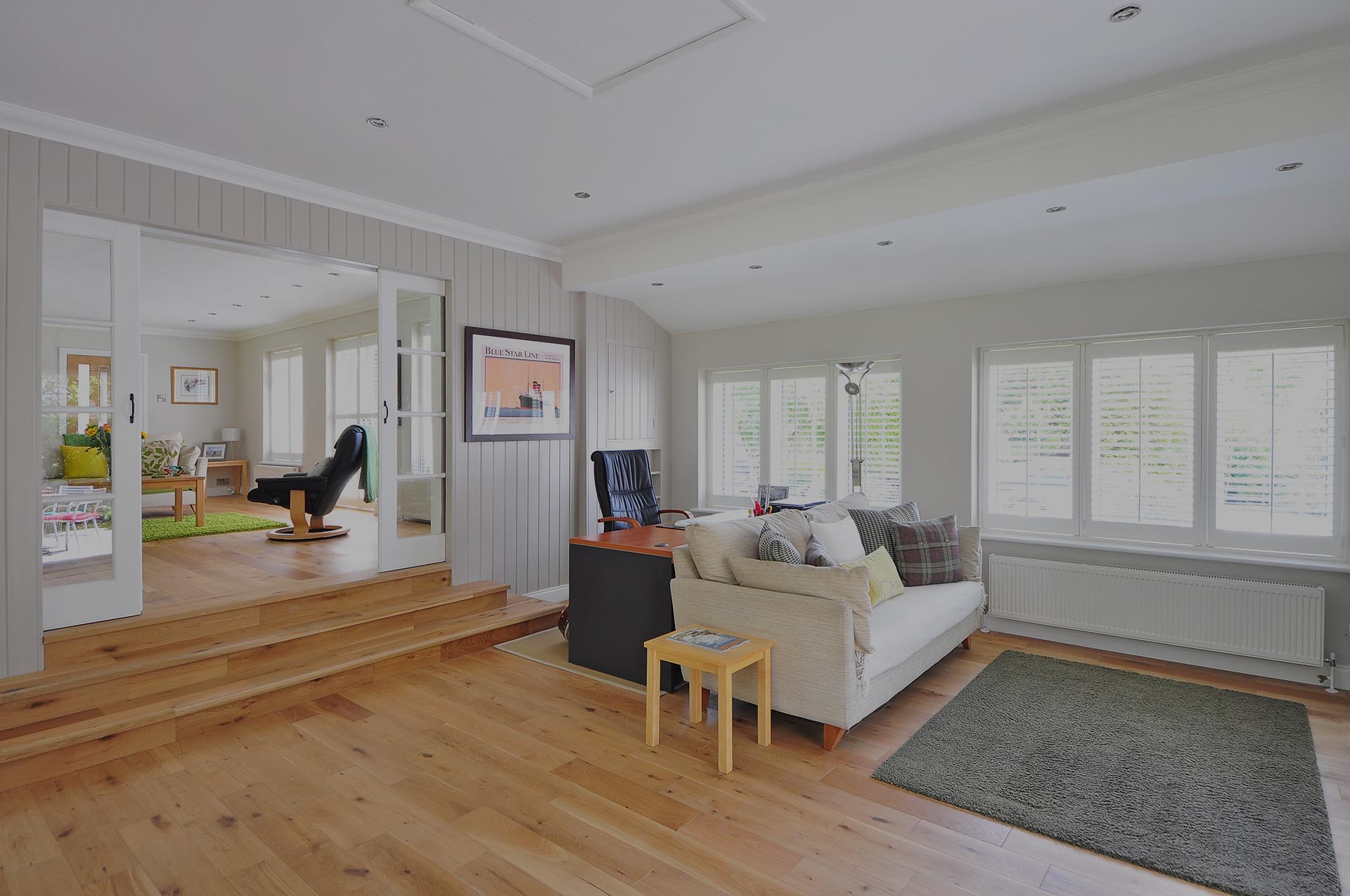 Living room with new wood floors and white walls