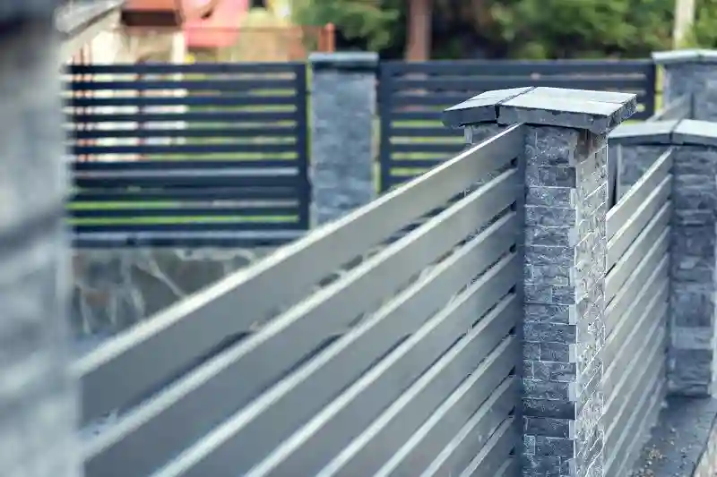 modern fence with stone pillars