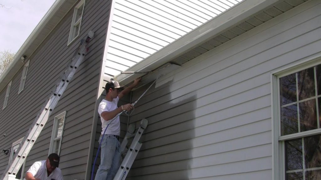 Painting the vinyl siding of a home white