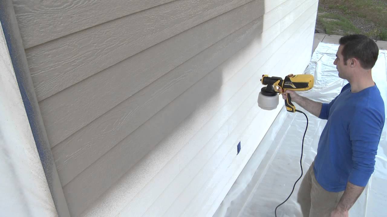 Painting side of home white with spray